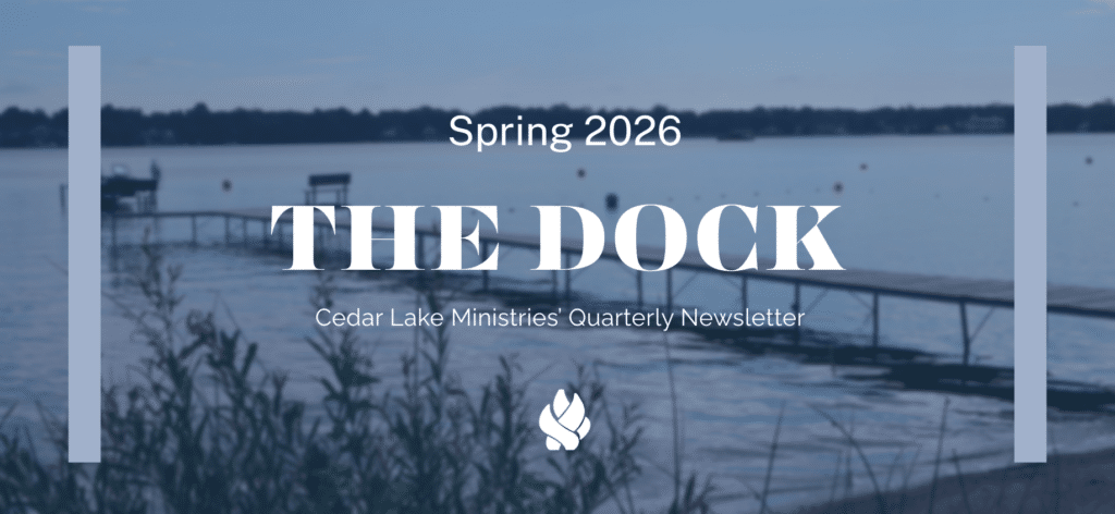 A lake dock extends over calm water with benches, plants in the foreground, and text overlay announcing "The Dock" Spring 2026 Cedar Lake Ministries quarterly newsletter.